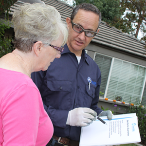 Chris Caldera, owner of Caldera Power Services going over services with a lady customer.